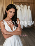 Close-up of the plunging V-neckline and smooth satin fabric on a sleeveless bridal gown