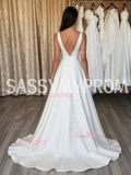 Elegant low-back satin A-line wedding dress with a flowing train.