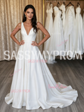Elegant low-back satin A-line wedding dress with a flowing train