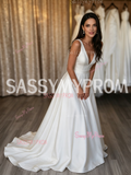 Elegant low-back satin A-line wedding dress with a flowing train