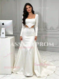 Full front view of sleek white satin mermaid wedding dress with long sleeves, square neck and cut-out sides
