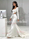 Side view of white long sleeve satin mermaid wedding dress showing fit-and-flare skirt and train
