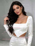 Close-up of square neckline and beaded cut-out waist on white long sleeve satin mermaid wedding dress