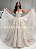 Front view holding out the full tulle A-line skirt of ivory lace appliqué wedding dress