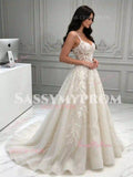 Ivory tulle ball gown wedding dress with floral lace appliqués trailing the skirt