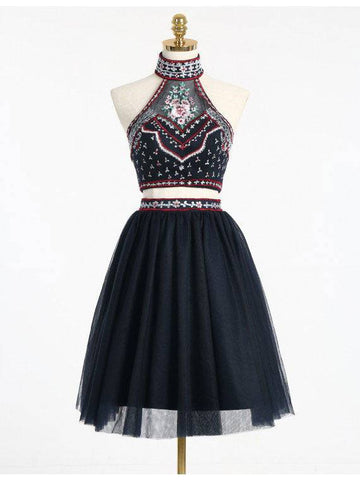 Black halter dress on mannequin with patterned fitted bodice and full tulle skirt | PicSEO 1787445892676