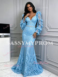 Three-quarter view of an elegant light blue trumpet mermaid formal gown featuring long sheer lace sleeves and floor-length train