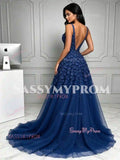Back view of navy blue backless V-neck prom dress with 3D flower appliqués and tulle sweep train