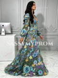 Side profile of the colorful 3D flower tulle evening gown featuring long puff sleeves and floor-length skirt