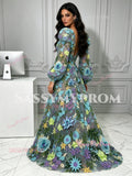 Back view showing the low back design and vibrant colorful floral embroidery on the tulle ball gown train