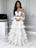 Full-length front profile of a boho white two-piece off-the-shoulder ball gown with crystal-encrusted waist belt and tiered tulle ruffles.