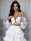 Close-up of boned sweetheart bustier top with crystal-encrusted trim, waist cutout detail, and sheer tulle puff sleeves on a white prom dress.